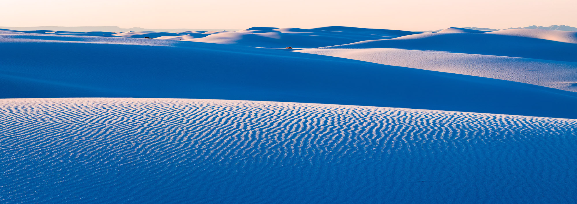 This photograph of white sand dunes at sunrise is a stunning representation of the natural beauty that surrounds us. In the distance...